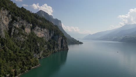 passing by beautiful mountain scenery and fluffy clouds on a sunny day on lake walensee, close to walenstadt