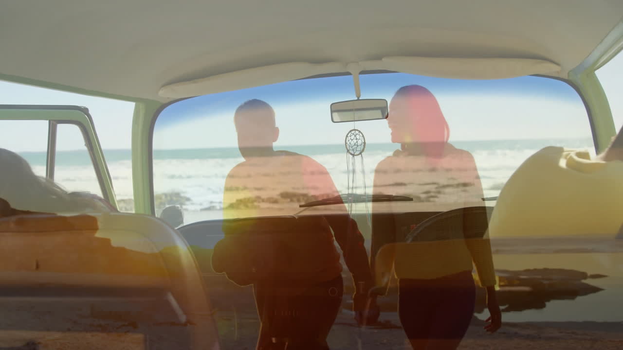 Walking on beach, couple holding hands seen through car window, creating animation
