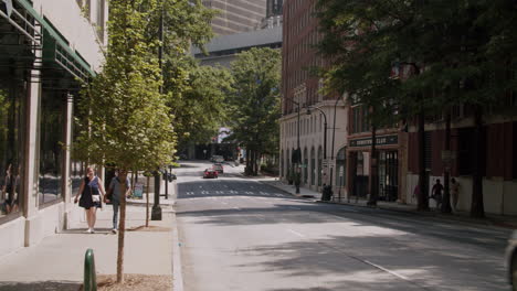 city street scene with cars and pedestrians
