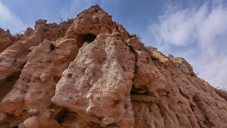 The-rugged-cliffs-along-the-Morocco-coastline---time-lapse,-tilt-up-sliding-dynamic-motion