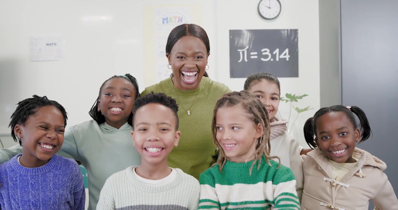 African American teacher leaning in speaking and guiding kids into smiling rows by ?=3