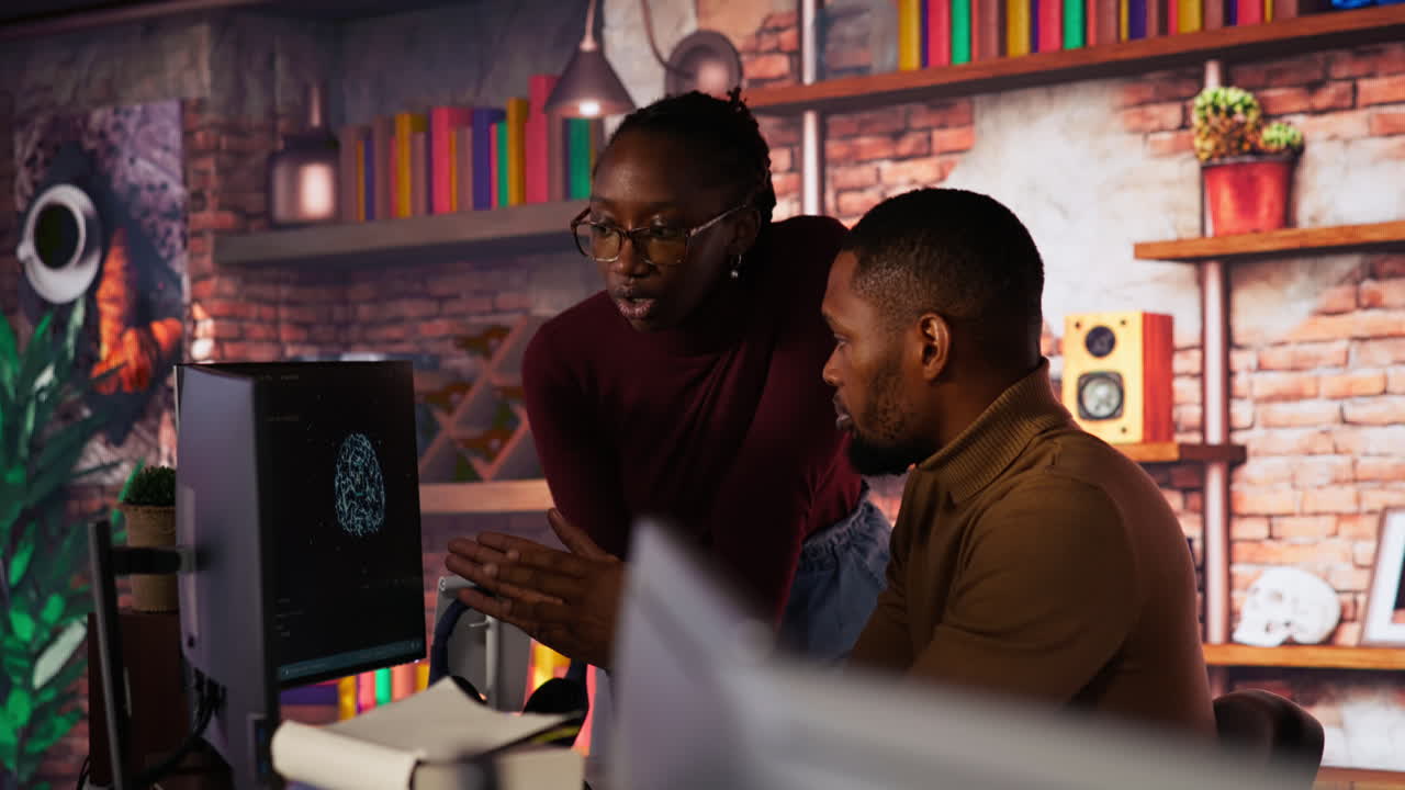 Team of AI startup workers conducting code review on PC to fix bugs