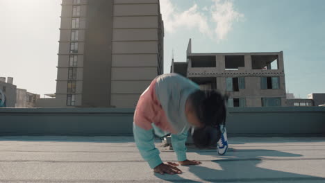 dancing-man-jumping-somersault-breakdancer-practicing-dance-routine-on-rooftop-in-urban-city