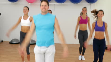 Aerobics-instructor-leading-a-happy-class-of-women