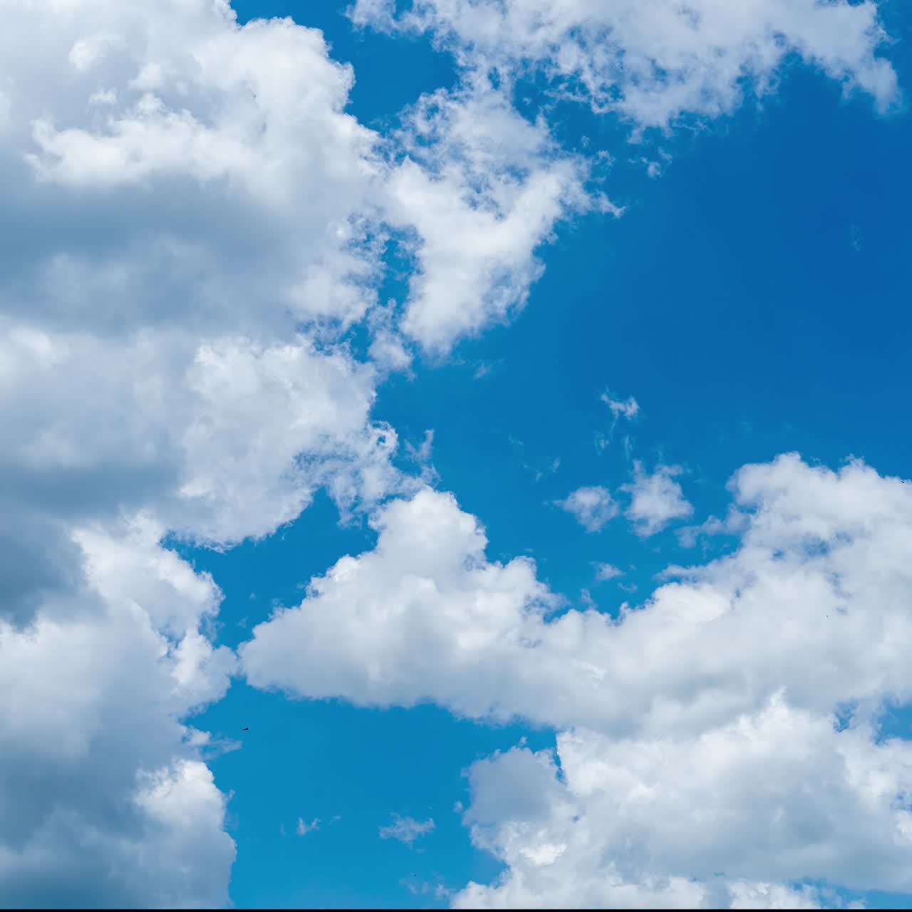 Bright blue skies with white clouds passing by. Soft clouds transformation in the atmosphere. Timelapse