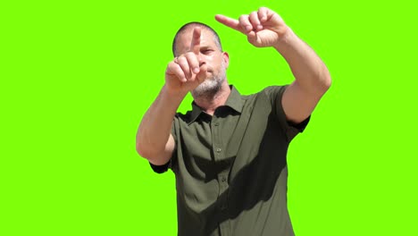 A-man-engaging-with-a-virtual-iPad-set-against-a-green-screen-background