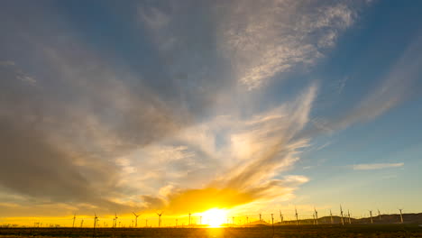 wind turbines in the foreground, cloudscape overhead in this stunningly colorful sunset time lapse