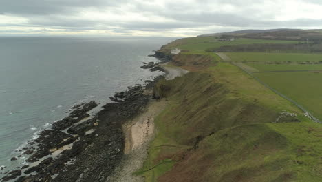 aerial view moving across the headland heading from dunbeath towards dunbeath castle, caithness, scotland