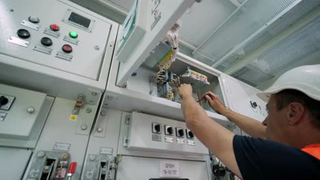 electrical engineers inspect the electrical systems at the equipment control cabinet