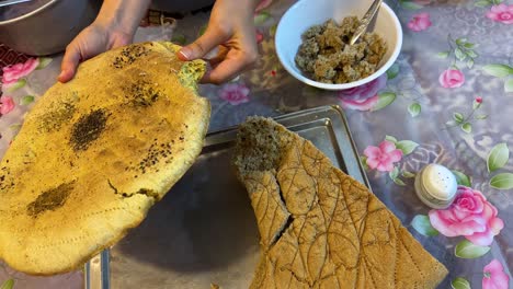 Pink-color-food-persian-cuisine-local-people-life-in-countryside-traditional-cooking-method-in-Iran-sheep-milk-dairy-base-food-serve-with-eggplant-tomato-healthy-dish-soak-local-bread-in-the-bowl-Iran