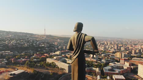 yerevan, armenia - 2nd september, 2021: the statue of mother armenia. mother armenia monument aerial close circular view. in background street, buildings victory park in yerevan