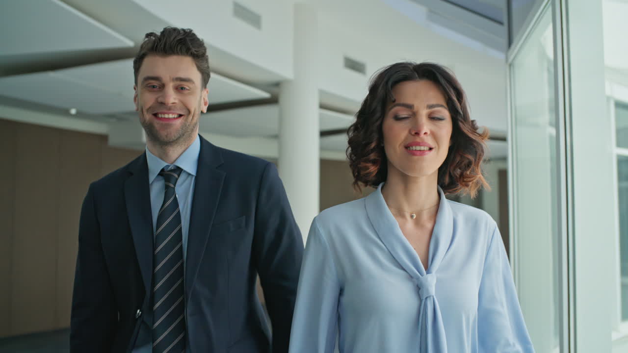 Corporate colleagues walking hallway modern office closeup. Company coworkers