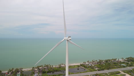 wind turbine spinning and creating renewable energy by the sea