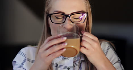 Female-Entrepreneur-Enjoying-Coffee-In-Office