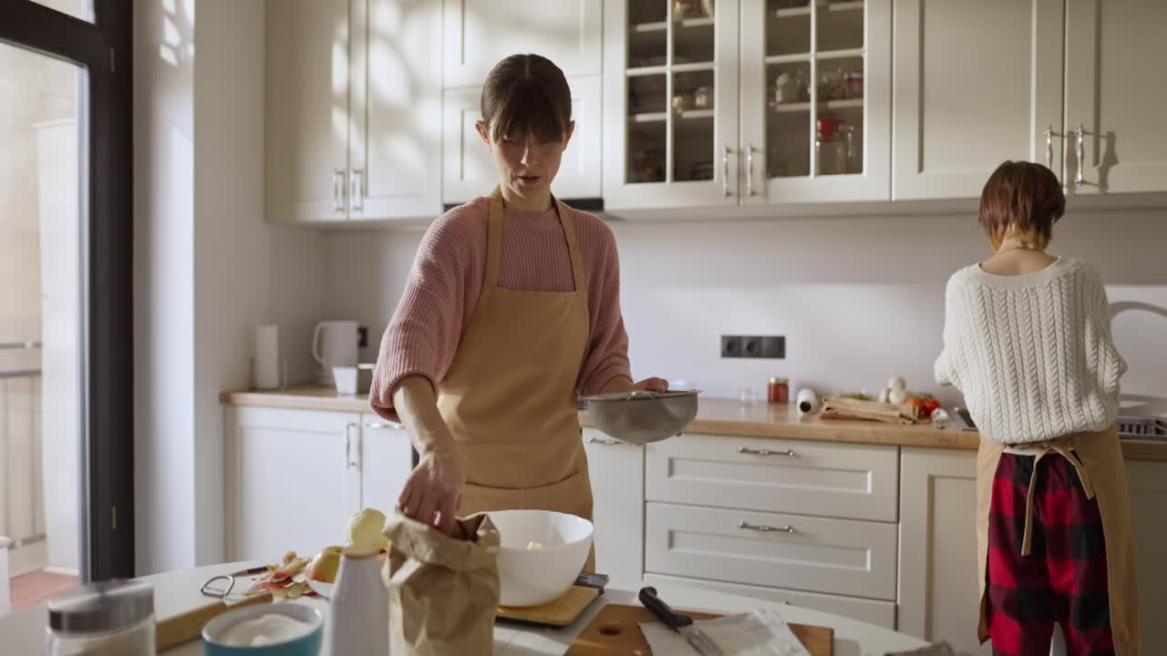 Women baking in a bright kitchen