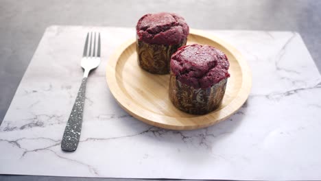 close up of muffins on table isolated on black