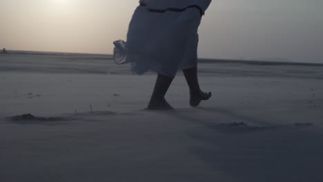 A-woman-walking-on-the-beach-windy-weather