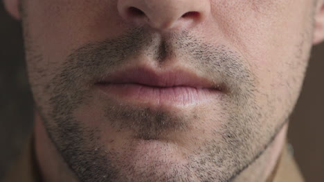 close up caucasian man mouth unshaved facial hair stubble