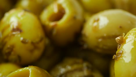 close-up of pickled olives with fork