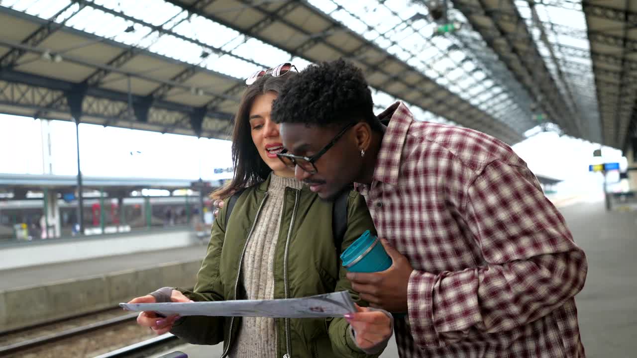 Couple looking at a map at a train station