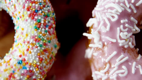 close-up of tasty doughnuts with sprinkles