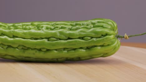 bitter melon on wooden cutting board
