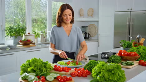 woman preparing a fresh salad in a bright kitchen