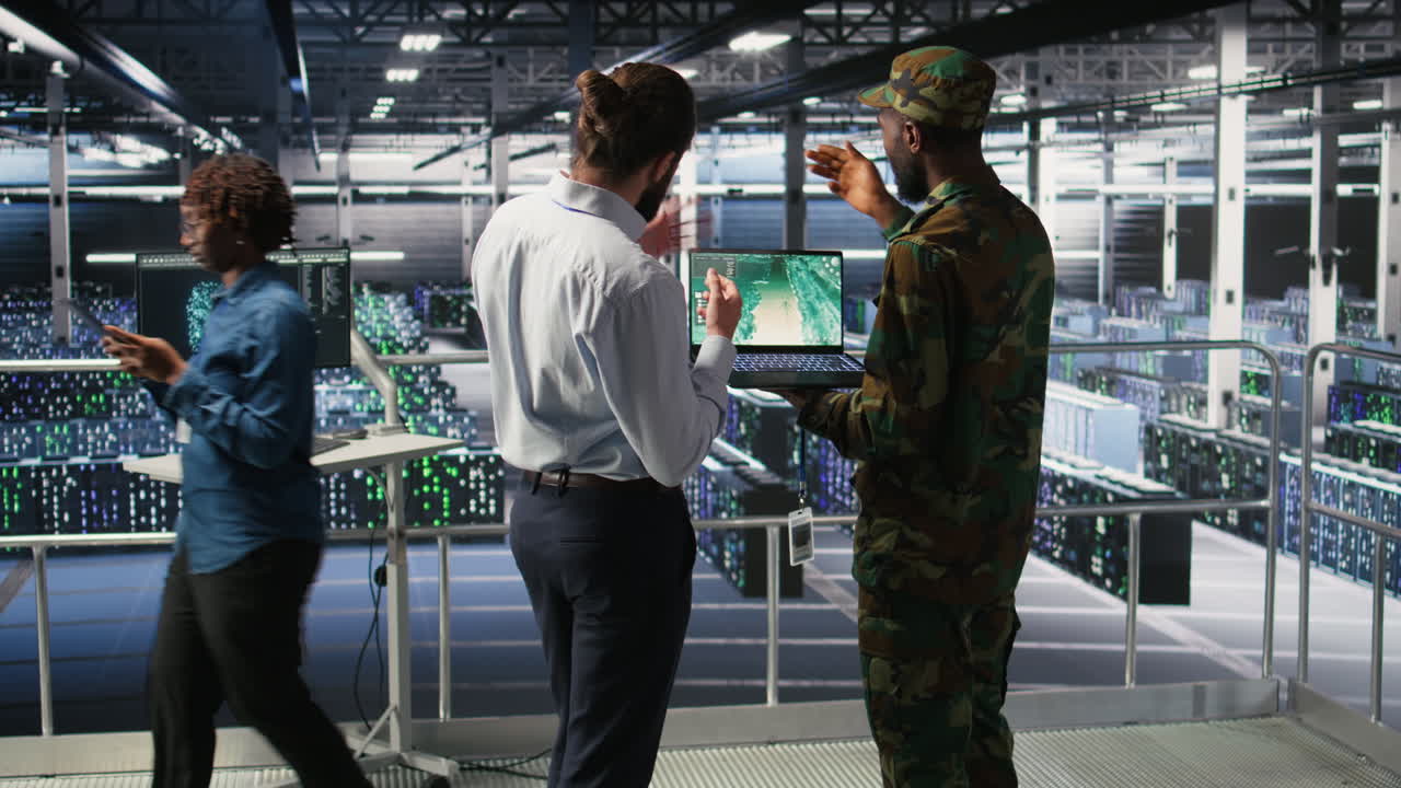 Military IT specialists in server hub using scanner tools to oversee battlefield