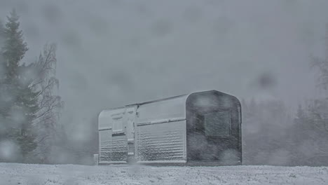 timelapse shot of rectangular wooden cabin throughout various season from cold winter to spring