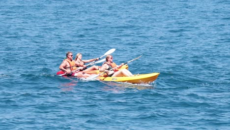 two kayaks paddling in the ocean near naples