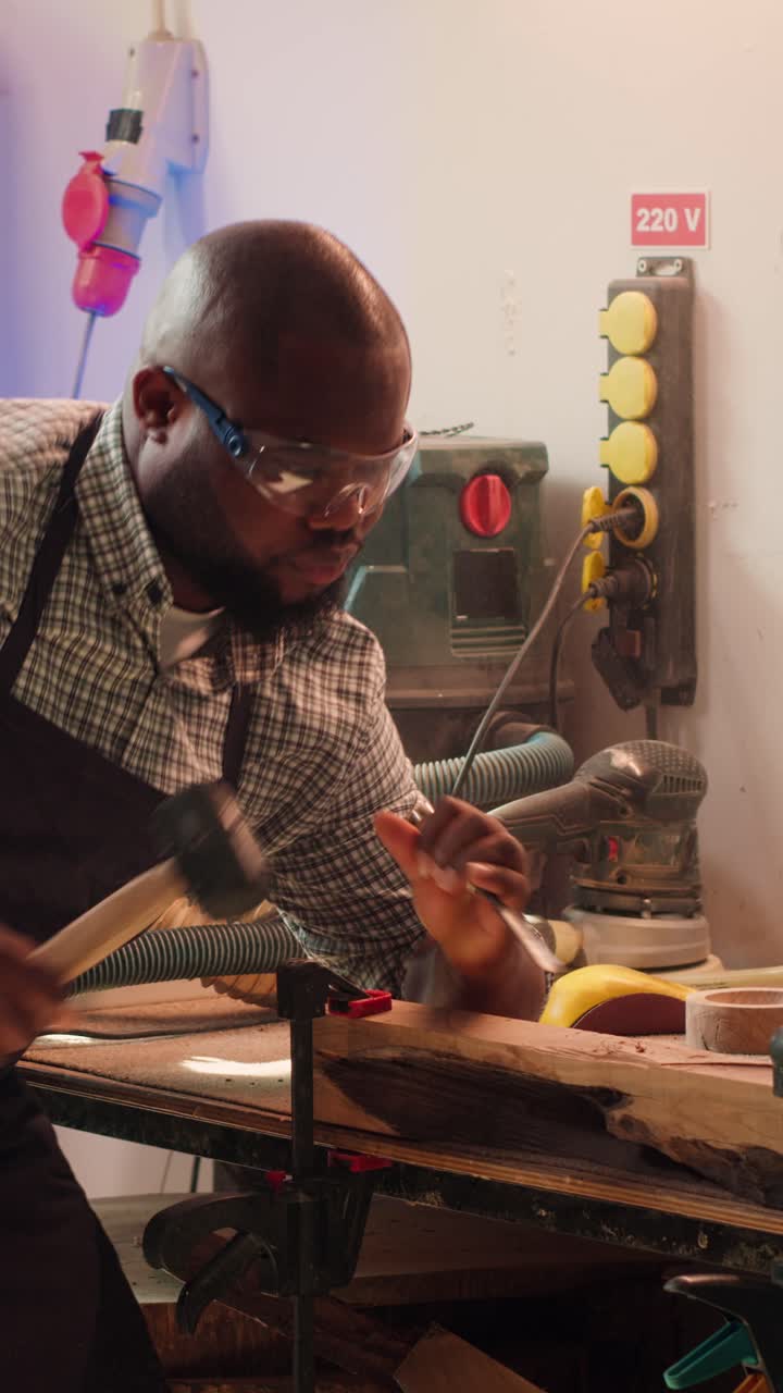 African American Carpenter Carving Wood with Chisel and Hammer
