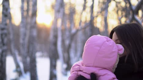 mother and baby in winter park