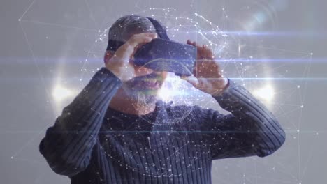 animation of network of connections over caucasian man wearing vr headset