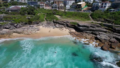 tamarama beach with tourists in sydney, nsw, australia - aerial shot