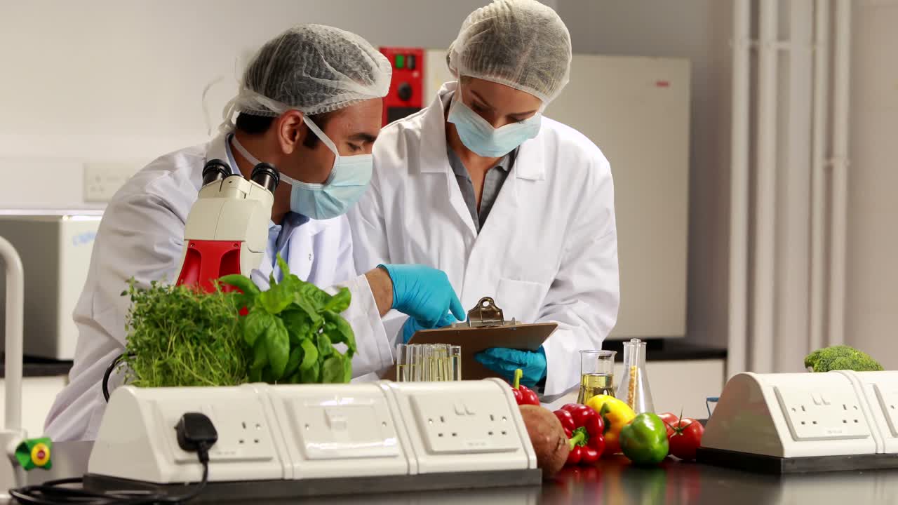Scientists experimenting on food together | Premium Stock Video Footage