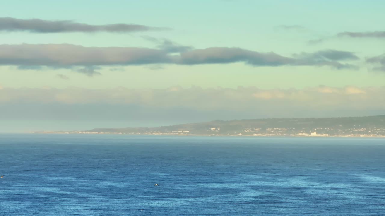 Serene Coastal Landscape with Distant Town
