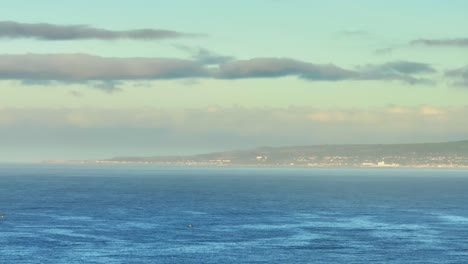 serene coastal landscape with distant town