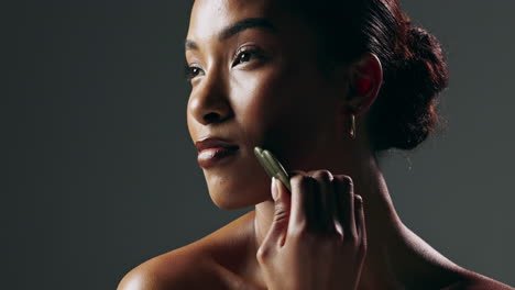 woman receiving jade roller facial massage