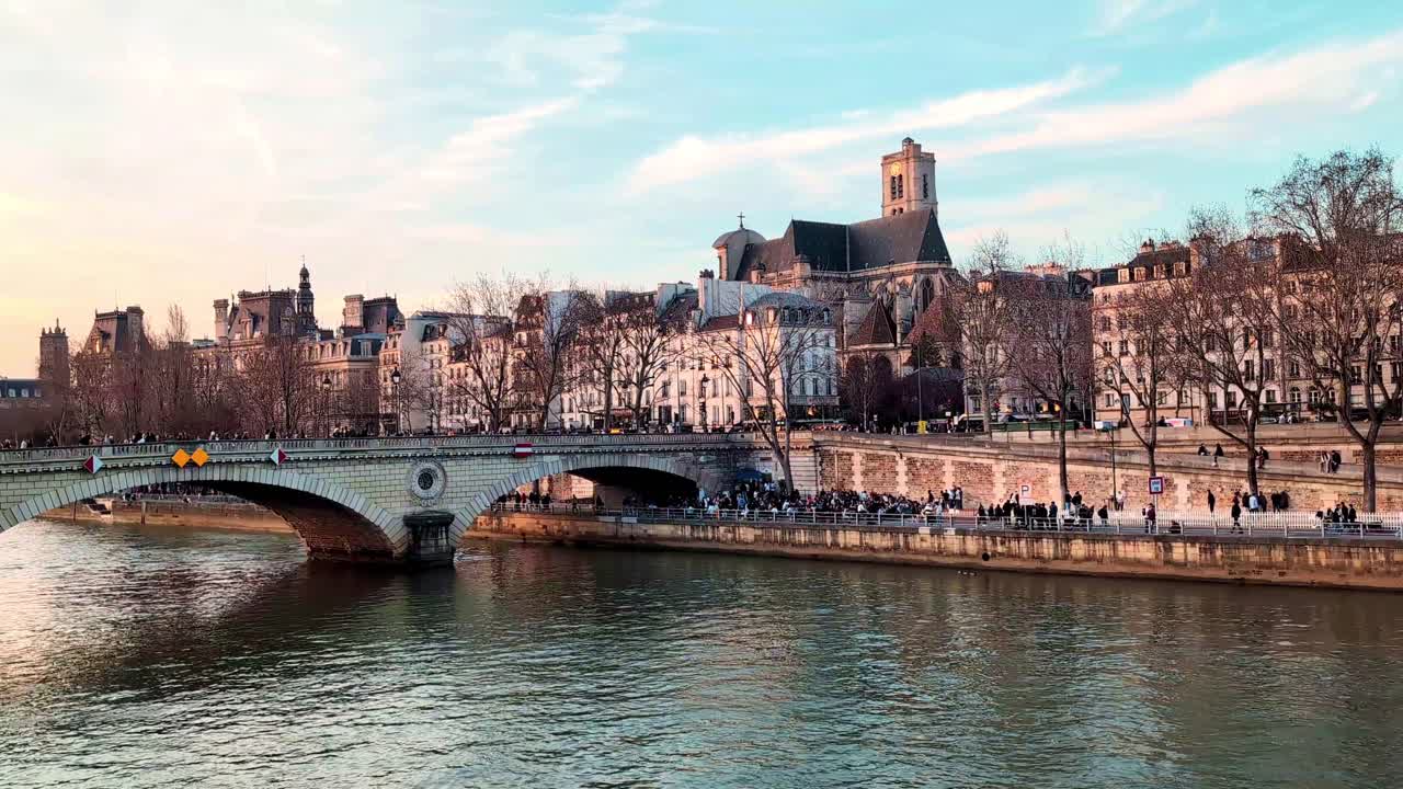 Paris Seine view with Notre-Dame and river traffic, sunny day