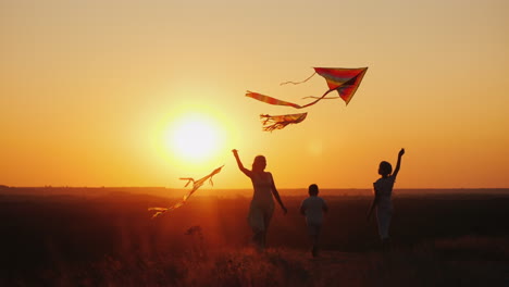 A-Woman-With-Two-Children---A-Girl-And-A-Boy-Playing-Kites-Active-Lifestyle