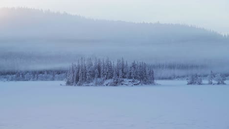 clouds with fog rolling over forest and mountain at winter near trondheim, norway