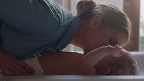 young-mother-kissing-happy-baby-laughing-enjoying-loving-mom-nurturing-toddler-at-home