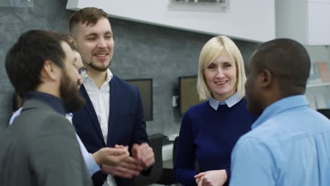 smiling colleagues chatting in office