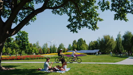 people enjoying a sustainable park with renewable energy technologies