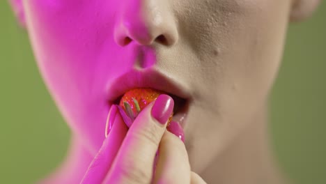 Woman-eating-a-piece-of-strawberry-seductively,-close-up-mouth-detail