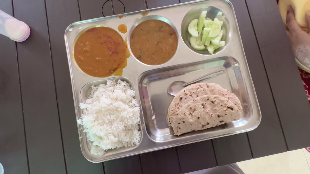 spinning shot of indian food at student mess, hospitals or canteen