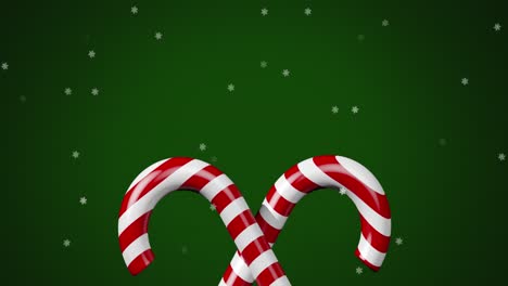 digital animation of multiple stars moving over two christmas candy cane against green background