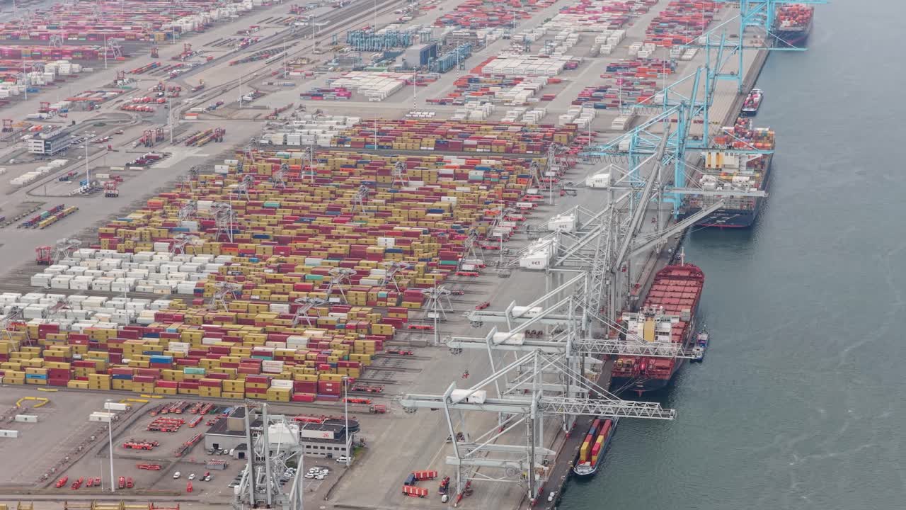 Dutch container terminal with ships carrying cargo abroad, Netherlands