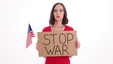 woman holding 'stop war' sign and american flag