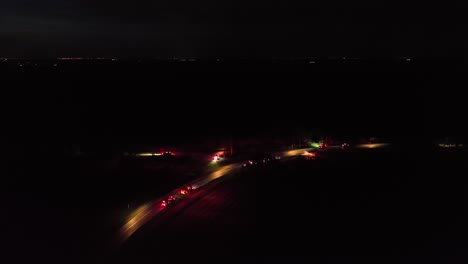 emergency on american highway at night.aerial wide shot. first aid help of ambulance vehicle and fire trucks. flashing red lights of cars. glowing lantern lights on street. pa, usa.